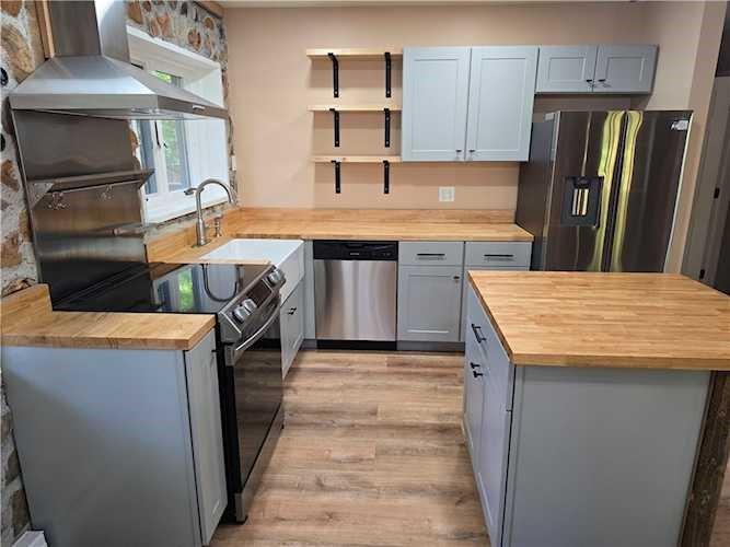 176 Kay Road Harrisville, PA 16038 - Photo 4 of 24 a kitchen with a refrigerator and a stove top oven