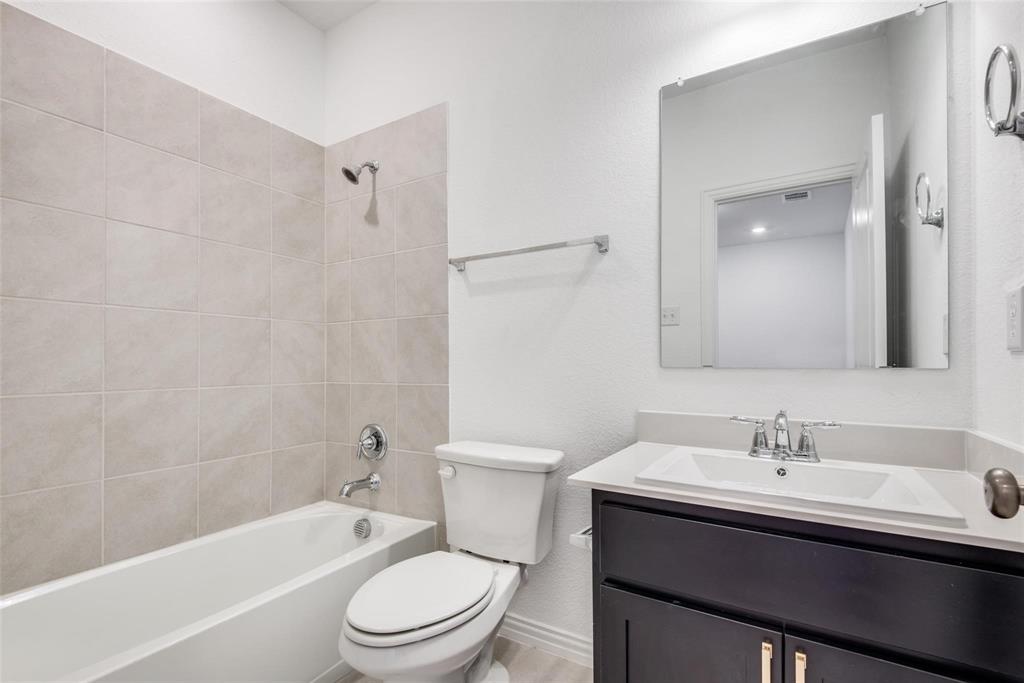 9915 Schramm Street Irving, TX 75063 - Photo 12 of 12 a bathroom with a sink a toilet and shower