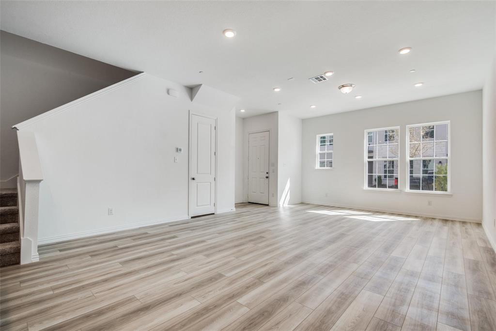 9915 Schramm Street Irving, TX 75063 - Photo 2 of 12 a view of an empty room with wooden floor and a window