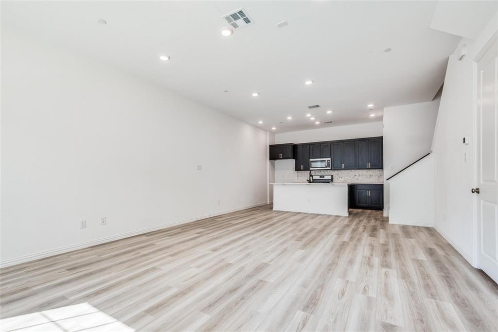 9915 Schramm Street Irving, TX 75063 - Photo 3 of 12 a view of a kitchen with a sink and a microwave