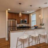 a kitchen with granite countertop a sink and refrigerator