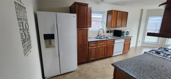a bathroom with a double vanity sink toilet and a mirror