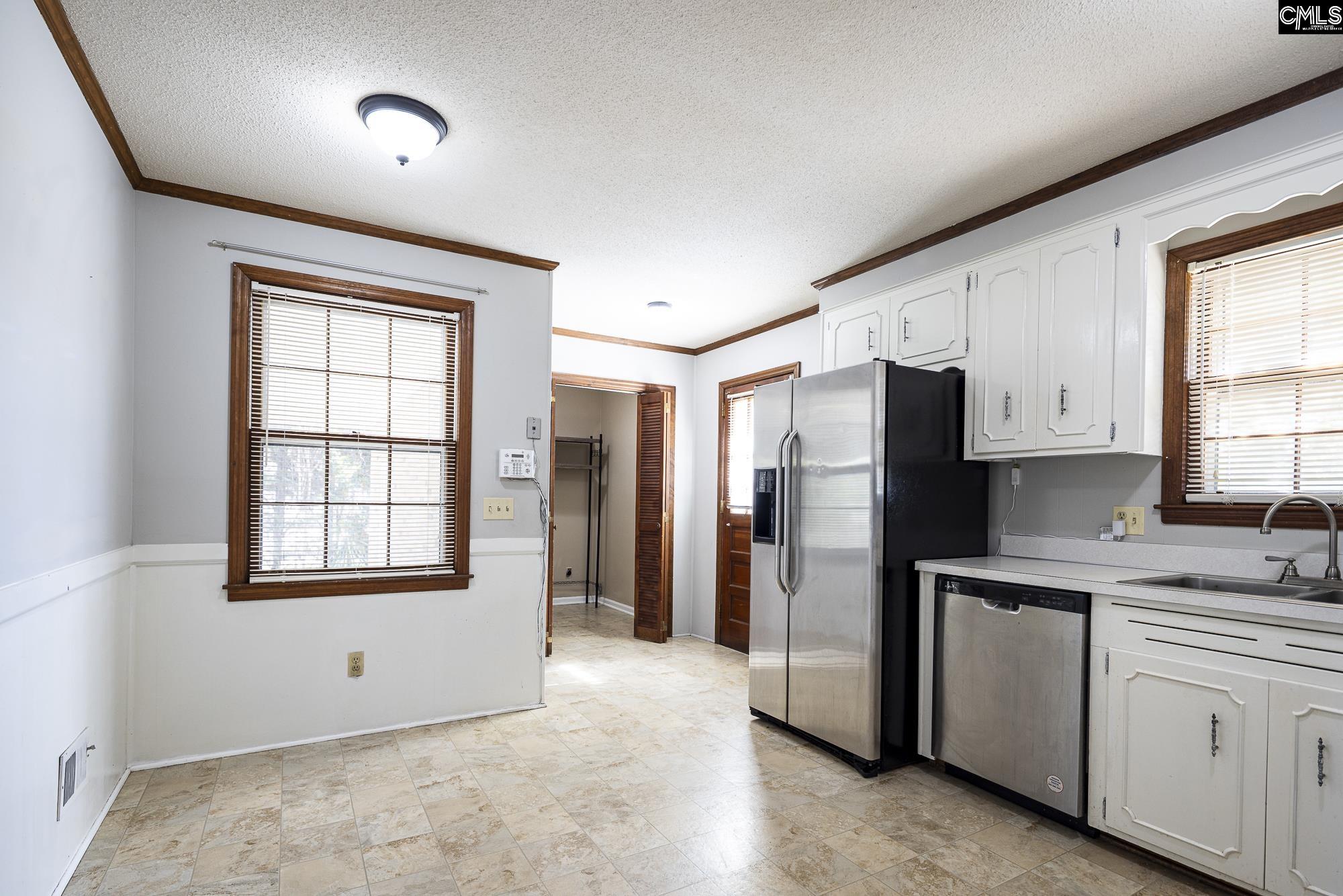 4083 Platt Springs Road West Columbia, SC 29170 - Photo 10 of 35 a kitchen with stainless steel appliances a refrigerator sink and cabinets