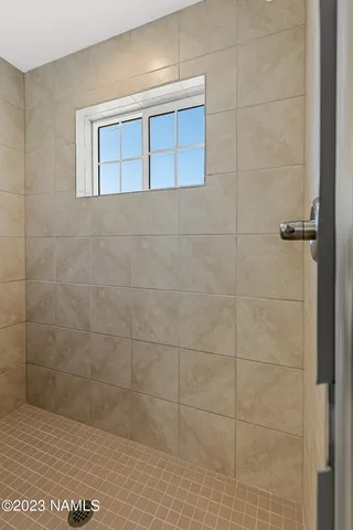 an empty room with closet and a ceiling fan