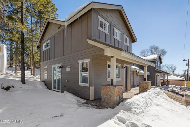a view of a house with snow on the road