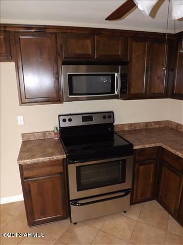 6520 West Berkeley Road Phoenix, AZ 85035 - Photo 4 of 22 a stove top oven sitting inside of a kitchen