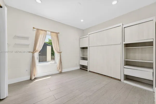 a view of an empty room with a window