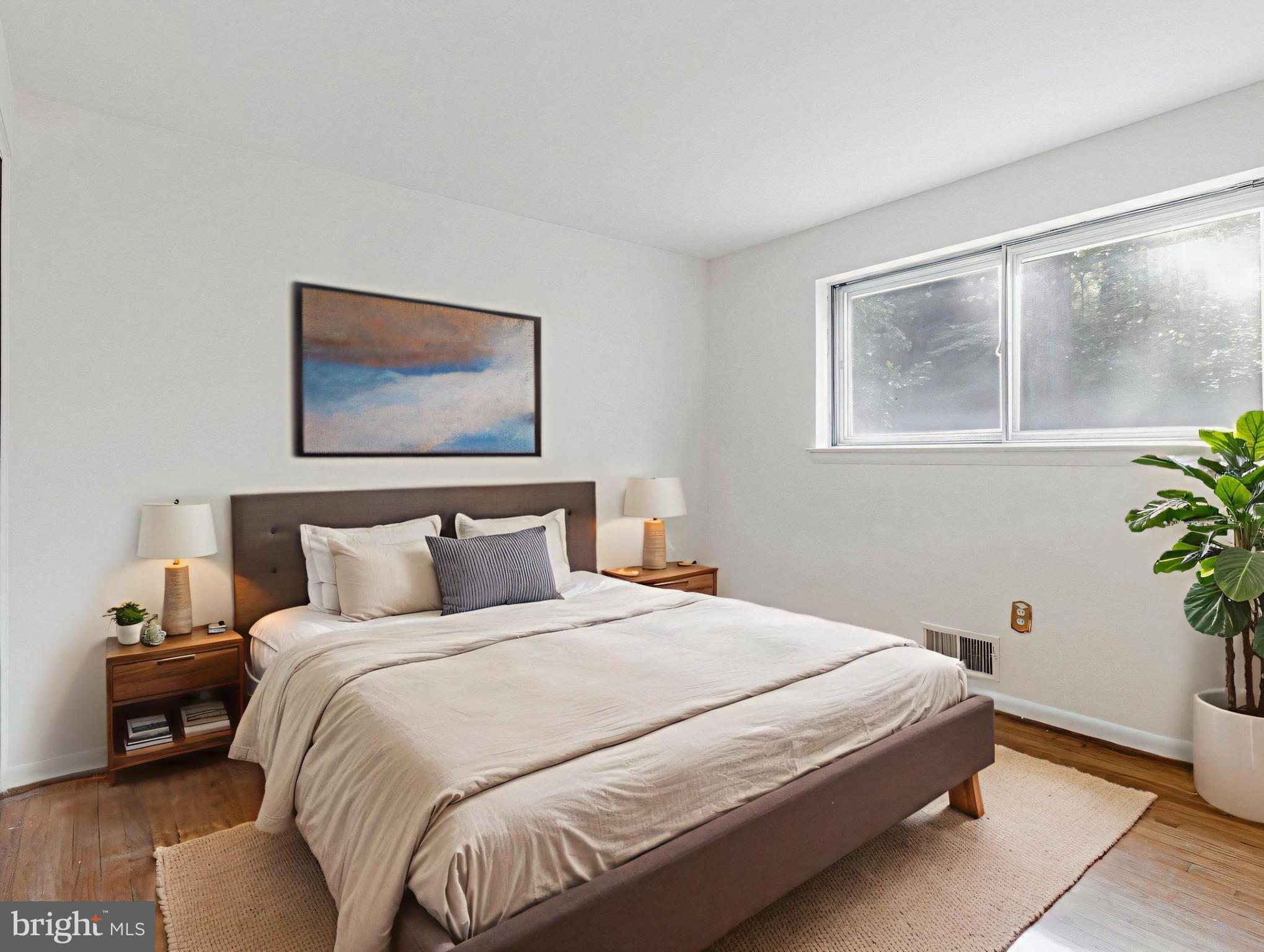 702 Lamberton Drive Silver Spring, MD 20902 - Photo 12 of 17 a bedroom with a bed and a painting on the wall