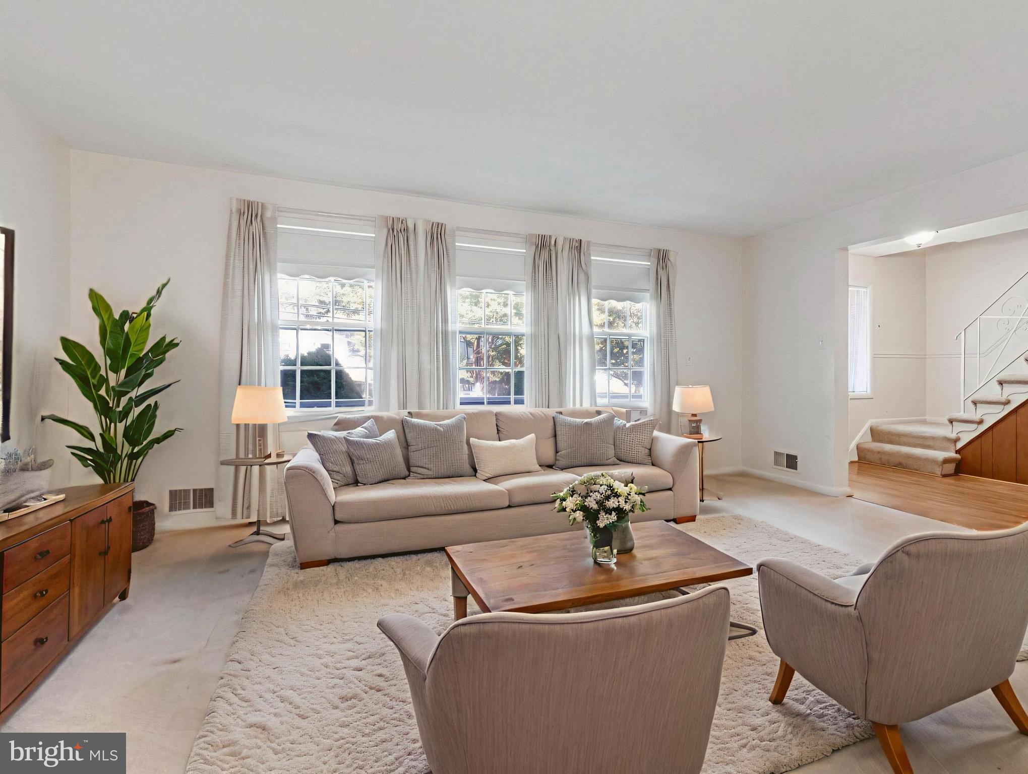 702 Lamberton Drive Silver Spring, MD 20902 - Photo 3 of 17 a living room with furniture potted plant and a window
