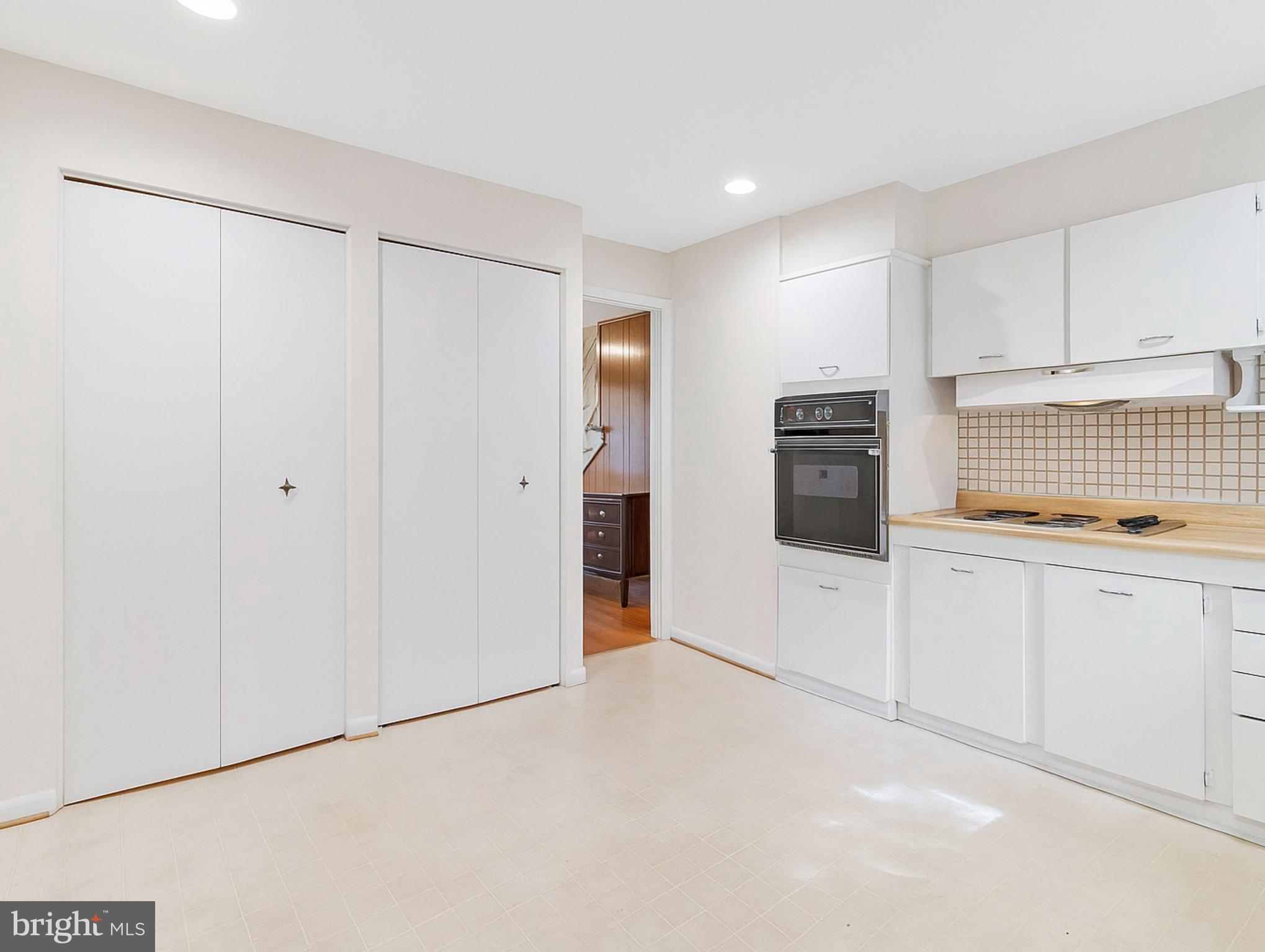 702 Lamberton Drive Silver Spring, MD 20902 - Photo 8 of 17 a view of an empty room with window and cabinet