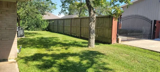 a view of backyard with tub and trees