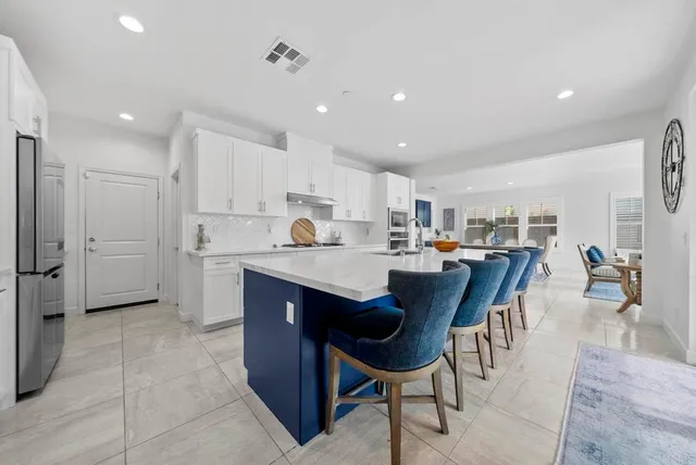 a view of kitchen with refrigerator dining table and chairs