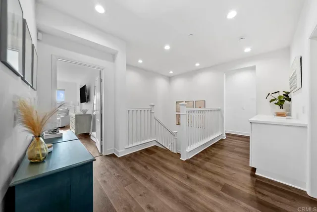 a bedroom with a large bed and a flat tv screen on a dresser