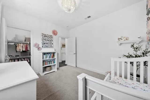 a large white kitchen with a stove a refrigerator and a sink