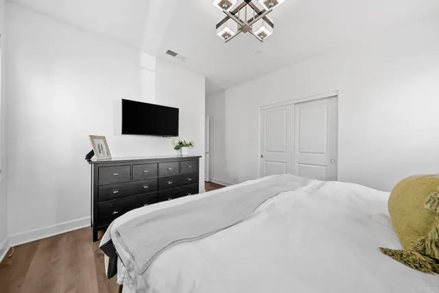 a bedroom with a bed table and a window
