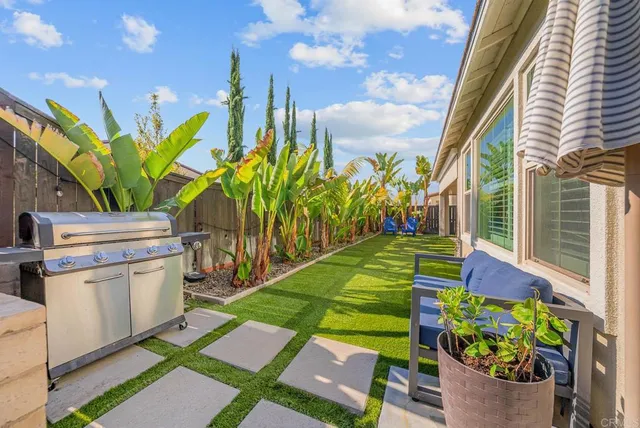 a swimming pool with outdoor seating and yard