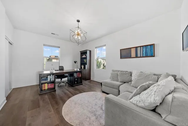 a living room with furniture and a dining table