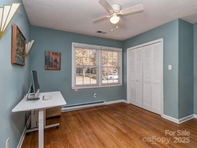 a workspace with furniture window and wooden floor