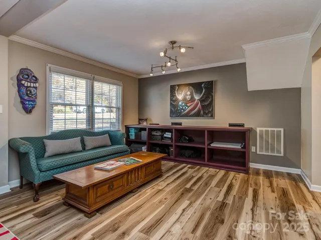 a living room with furniture a rug and a window