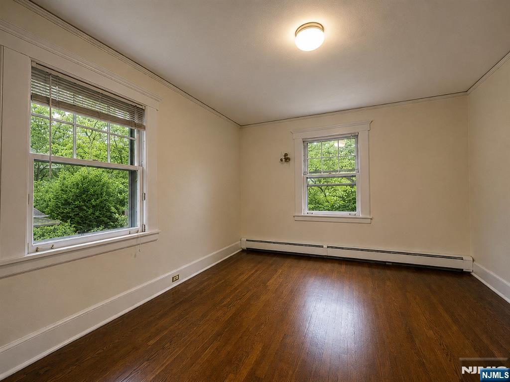 84 Valley View Avenue Ridgewood, NJ 07450 - Photo 10 of 20 an empty room with wooden floor and windows