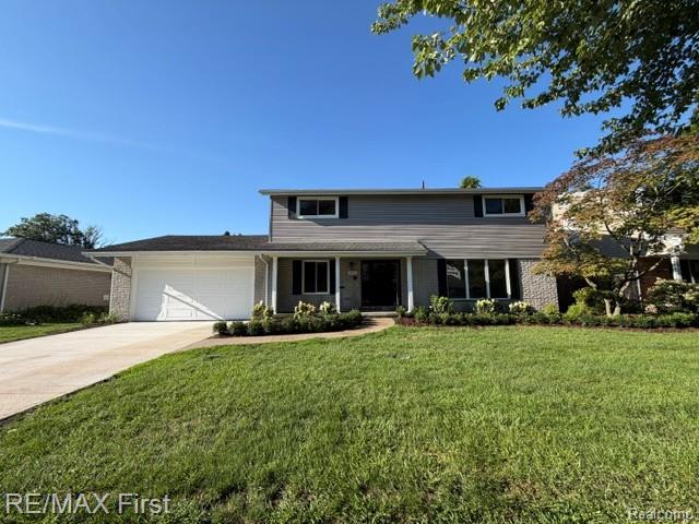 971 Canterbury Road Grosse Pointe, MI 48236 - Photo 1 of 30 Two-story residence featuring a gray siding exterior and a white garage door