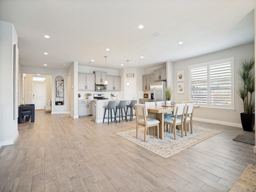 1612 Reed Drive Krum, TX 76249 - Photo 10 of 25 Open-concept living space featuring wood-finish flooring throughout