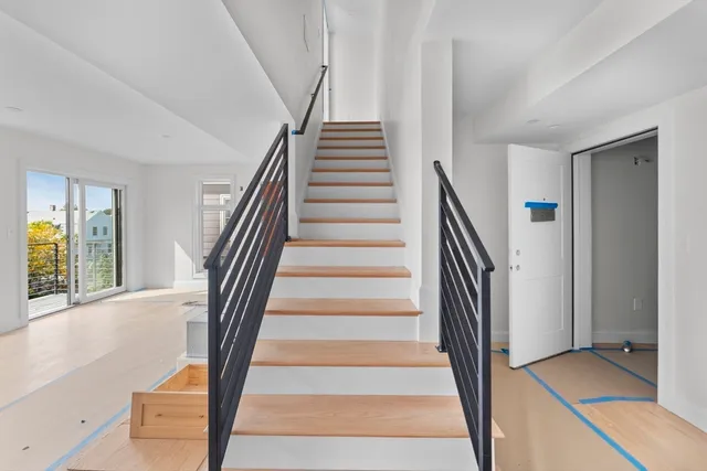 a view of staircase with white walls and a window