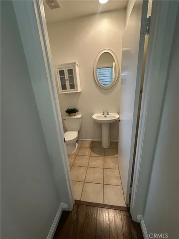 a bathroom with a toilet and a mirror