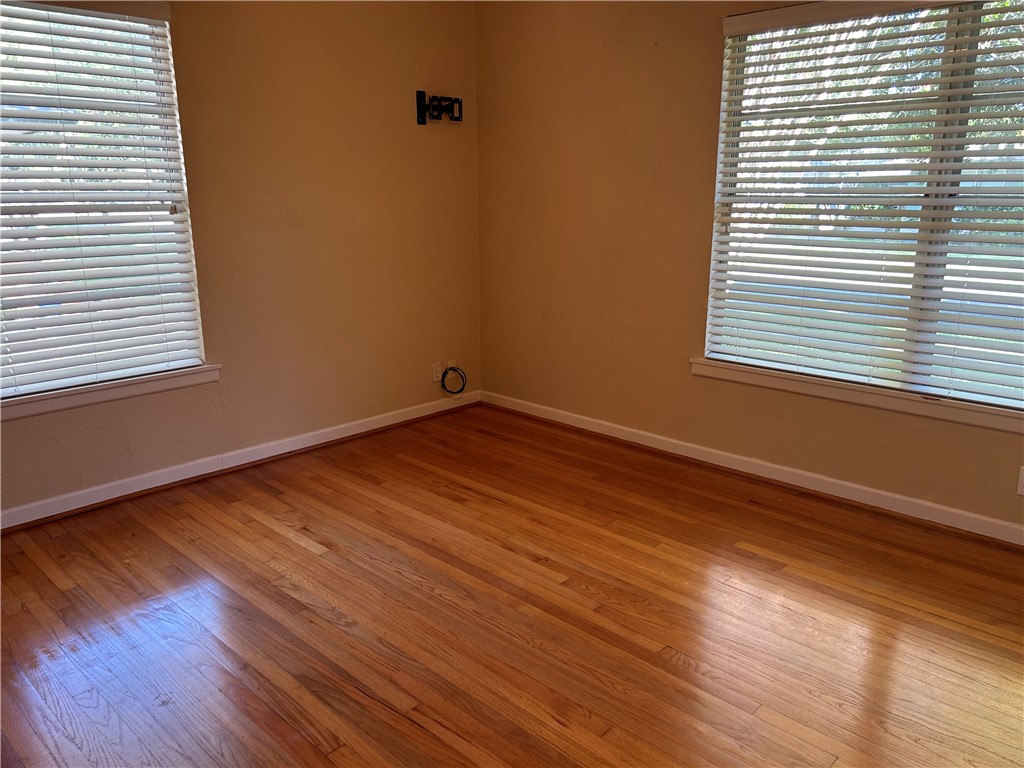 626 Bermuda Place Corpus Christi, TX 78411 - Photo 12 of 22 a view of an empty room with wooden floor and a window