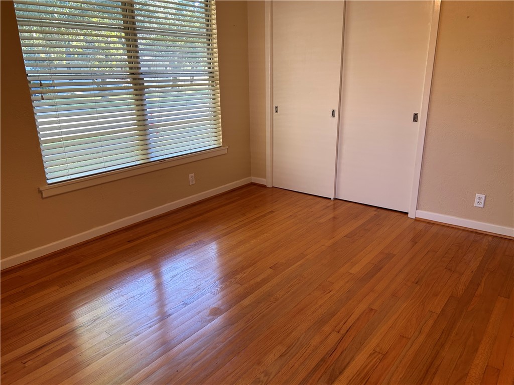 626 Bermuda Place Corpus Christi, TX 78411 - Photo 13 of 22 a view of an empty room with wooden floor and a window