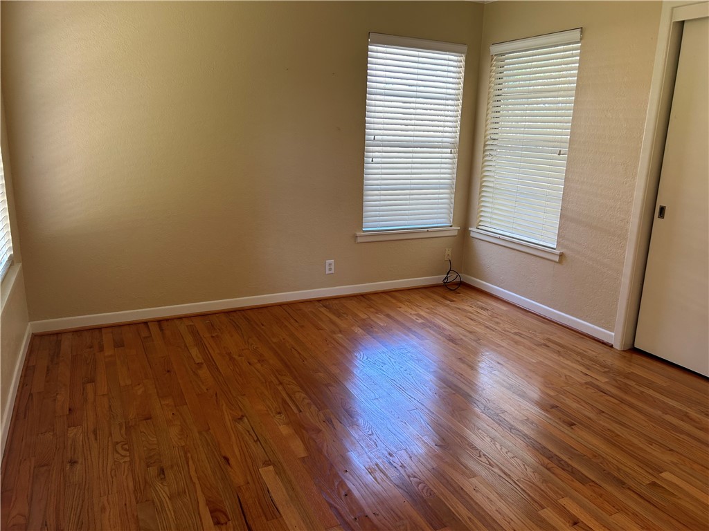 626 Bermuda Place Corpus Christi, TX 78411 - Photo 17 of 22 a view of an empty room with wooden floor and a window