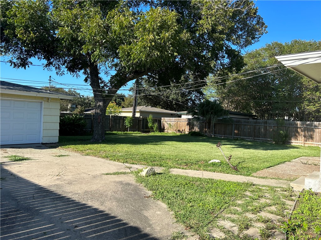 626 Bermuda Place Corpus Christi, TX 78411 - Photo 20 of 22 a front view of a house with a yard