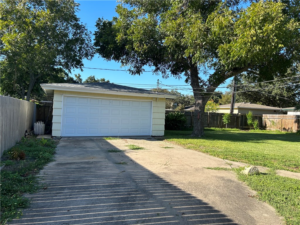 626 Bermuda Place Corpus Christi, TX 78411 - Photo 21 of 22 a front view of a house with a yard and garage