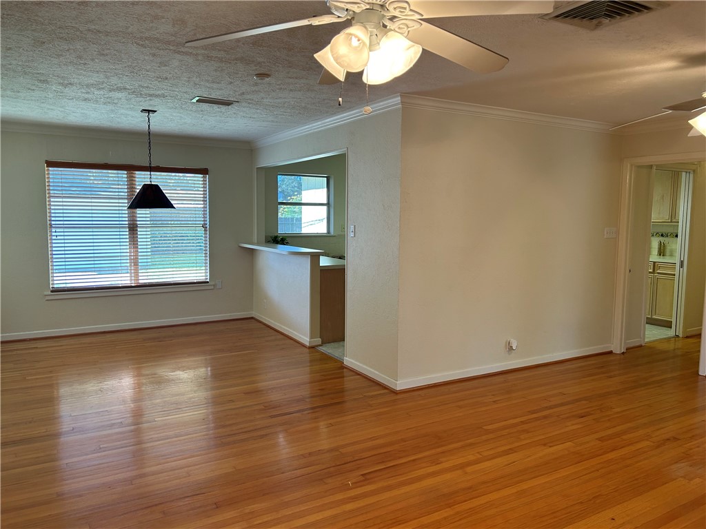 626 Bermuda Place Corpus Christi, TX 78411 - Photo 3 of 22 an empty room with wooden floor chandelier and windows