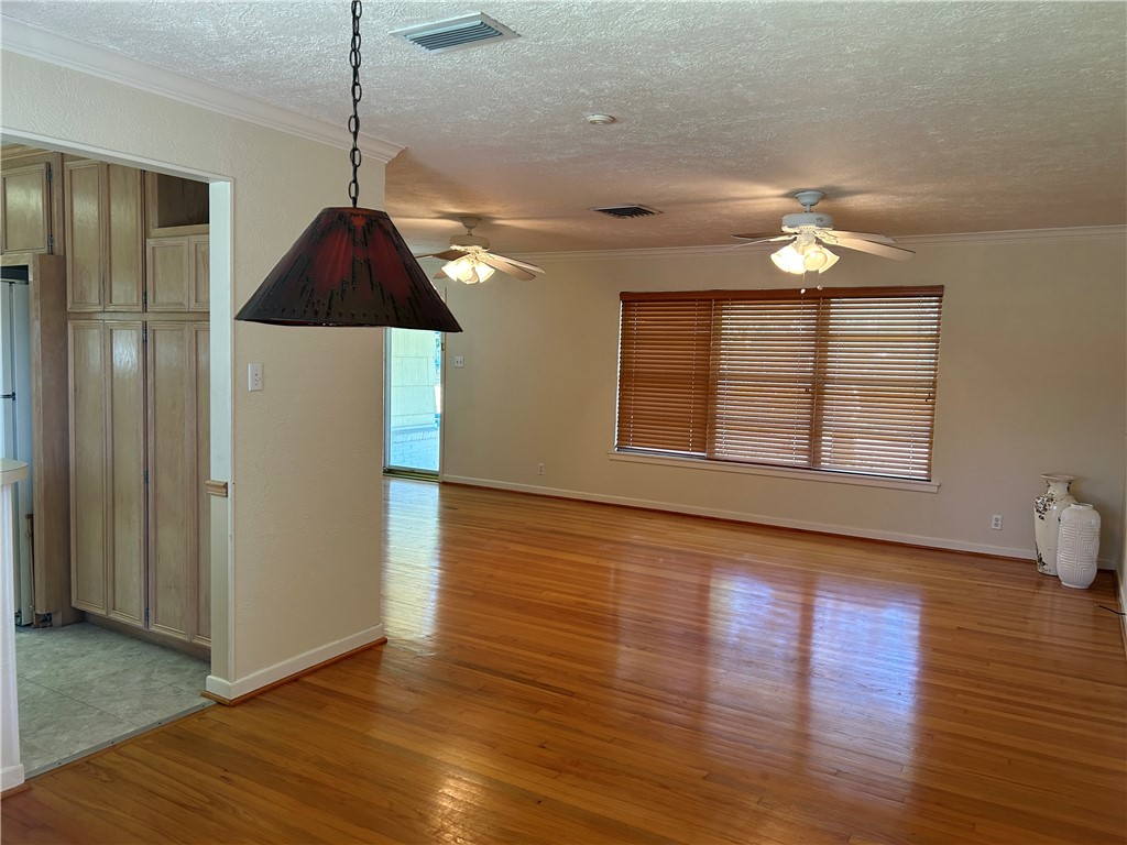 626 Bermuda Place Corpus Christi, TX 78411 - Photo 4 of 22 a view of empty room with wooden floor and fan