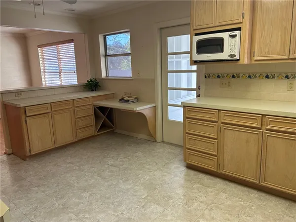 a kitchen with cabinets and window