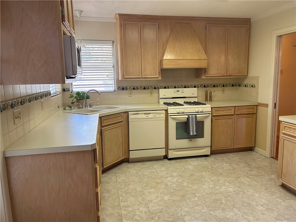 626 Bermuda Place Corpus Christi, TX 78411 - Photo 7 of 22 a kitchen with a stove sink and cabinets