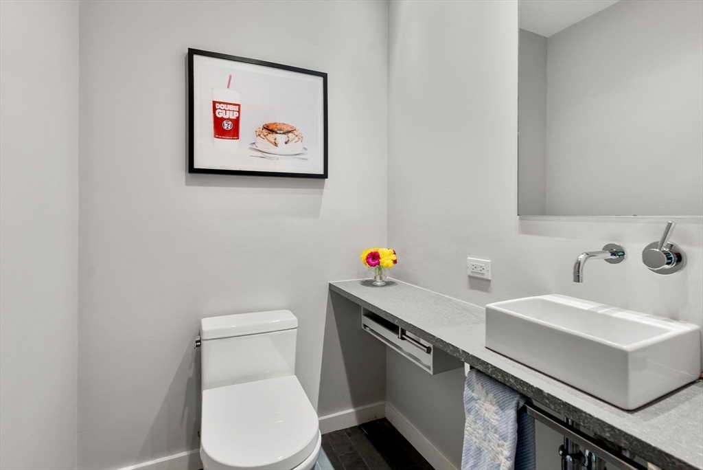 244 Heath Street Brookline, MA 02467 - Photo 15 of 36 a bathroom with a toilet a sink and a mirror