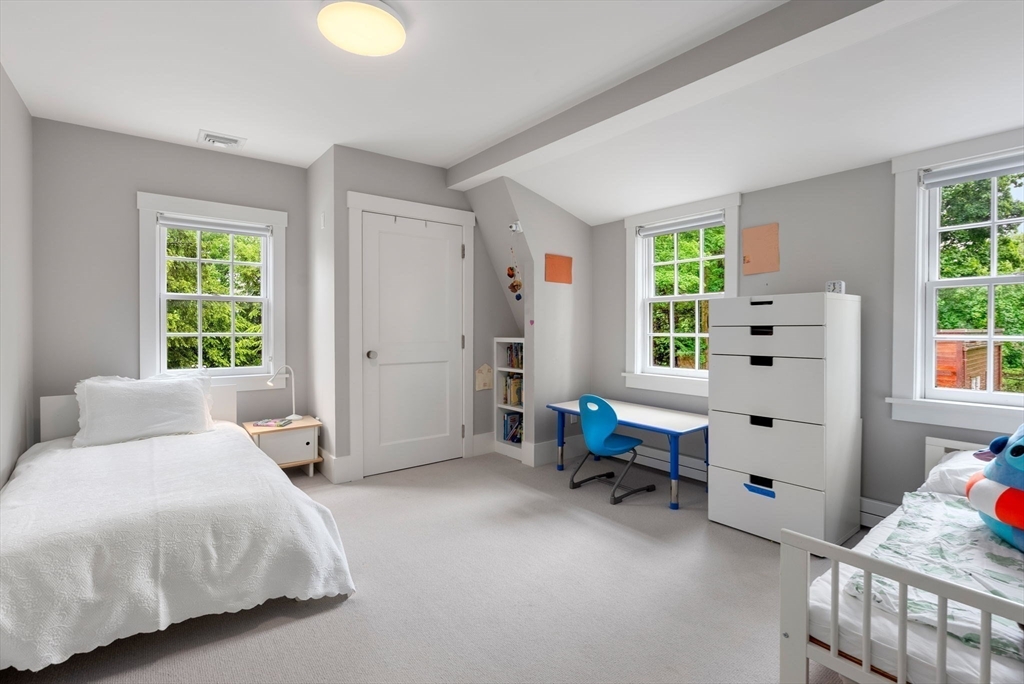 244 Heath Street Brookline, MA 02467 - Photo 19 of 36 a spacious bedroom with a bed and a window