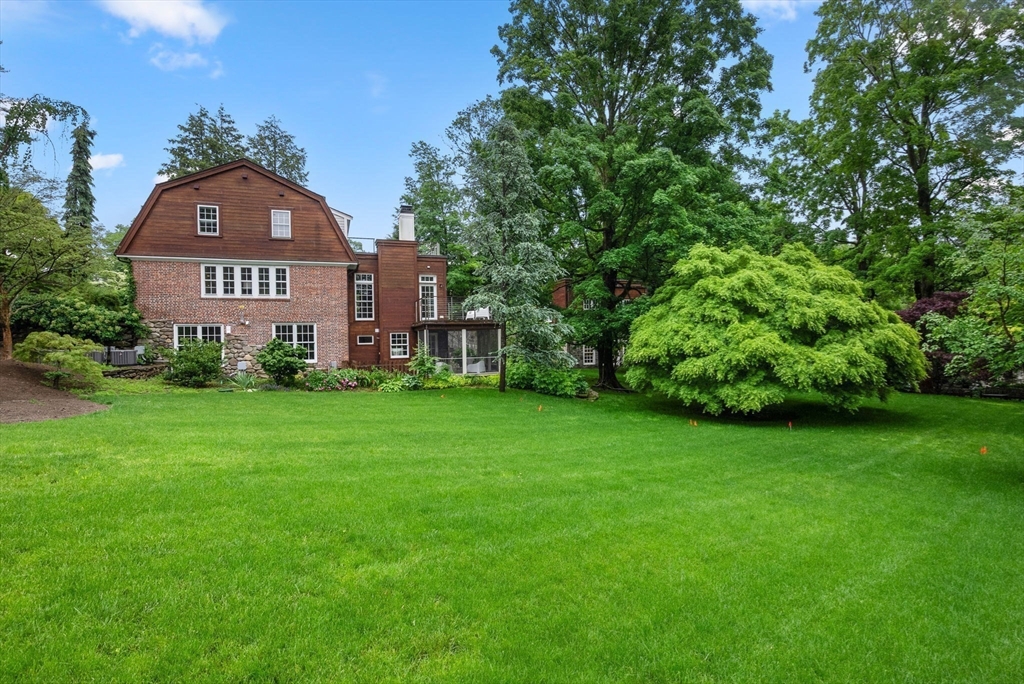 244 Heath Street Brookline, MA 02467 - Photo 2 of 36 a view of a big yard in front of a house with a large tree