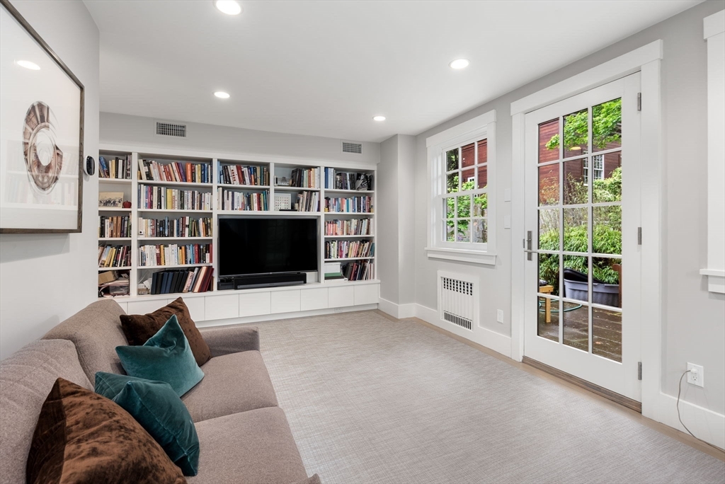 244 Heath Street Brookline, MA 02467 - Photo 24 of 36 a living room with furniture and a flat screen tv