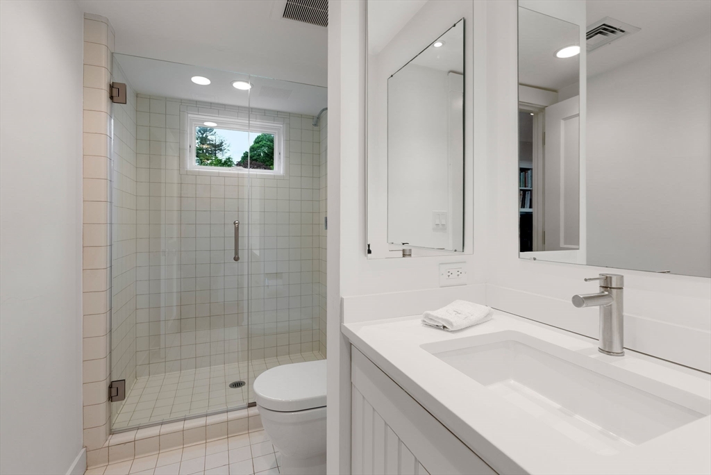 244 Heath Street Brookline, MA 02467 - Photo 27 of 36 a bathroom with a sink a toilet and shower
