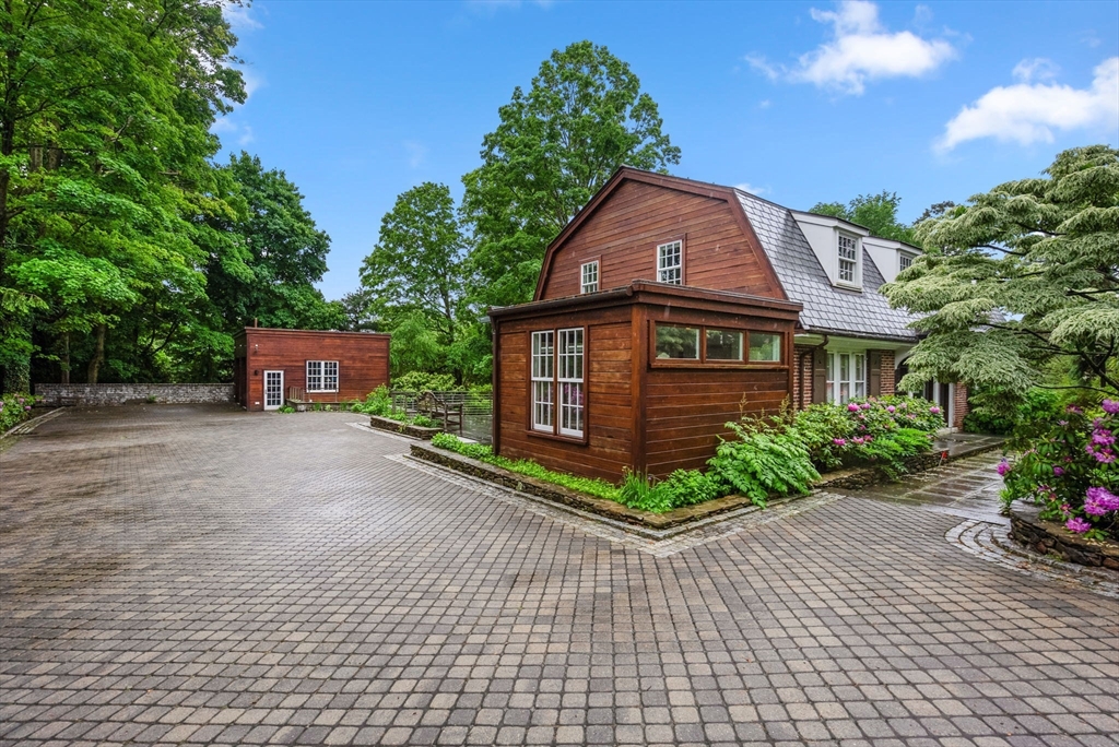 244 Heath Street Brookline, MA 02467 - Photo 32 of 36 a front view of a house with a yard and potted plants