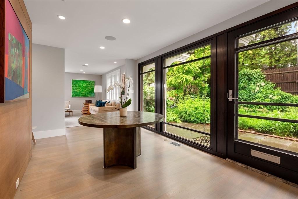244 Heath Street Brookline, MA 02467 - Photo 4 of 36 a living room with large windows and dining table