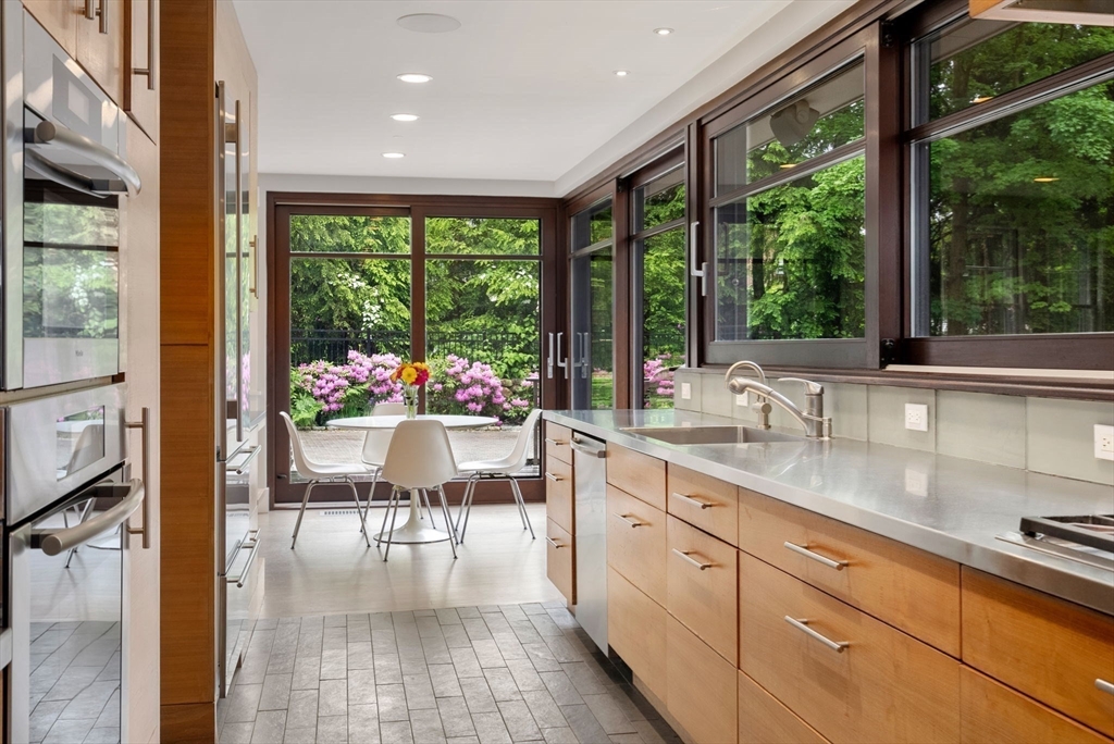 244 Heath Street Brookline, MA 02467 - Photo 5 of 36 a very nice looking kitchen with granite countertop a large window and white appliances