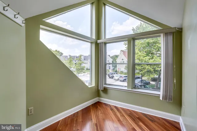 a view of a room with window and wooden floor