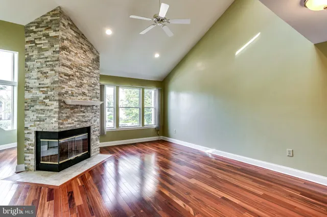 a view of an empty room with a fireplace and a window