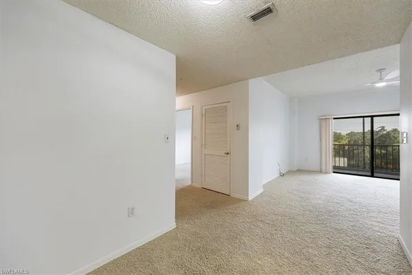 an empty room with windows and outdoor view