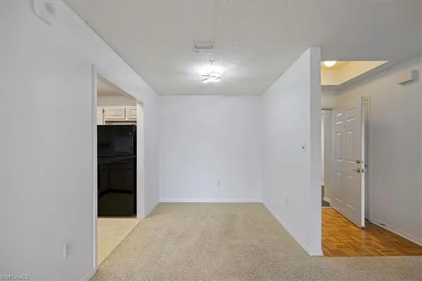 an empty room with closet and windows