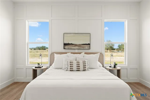 a bedroom with a large bed and a window